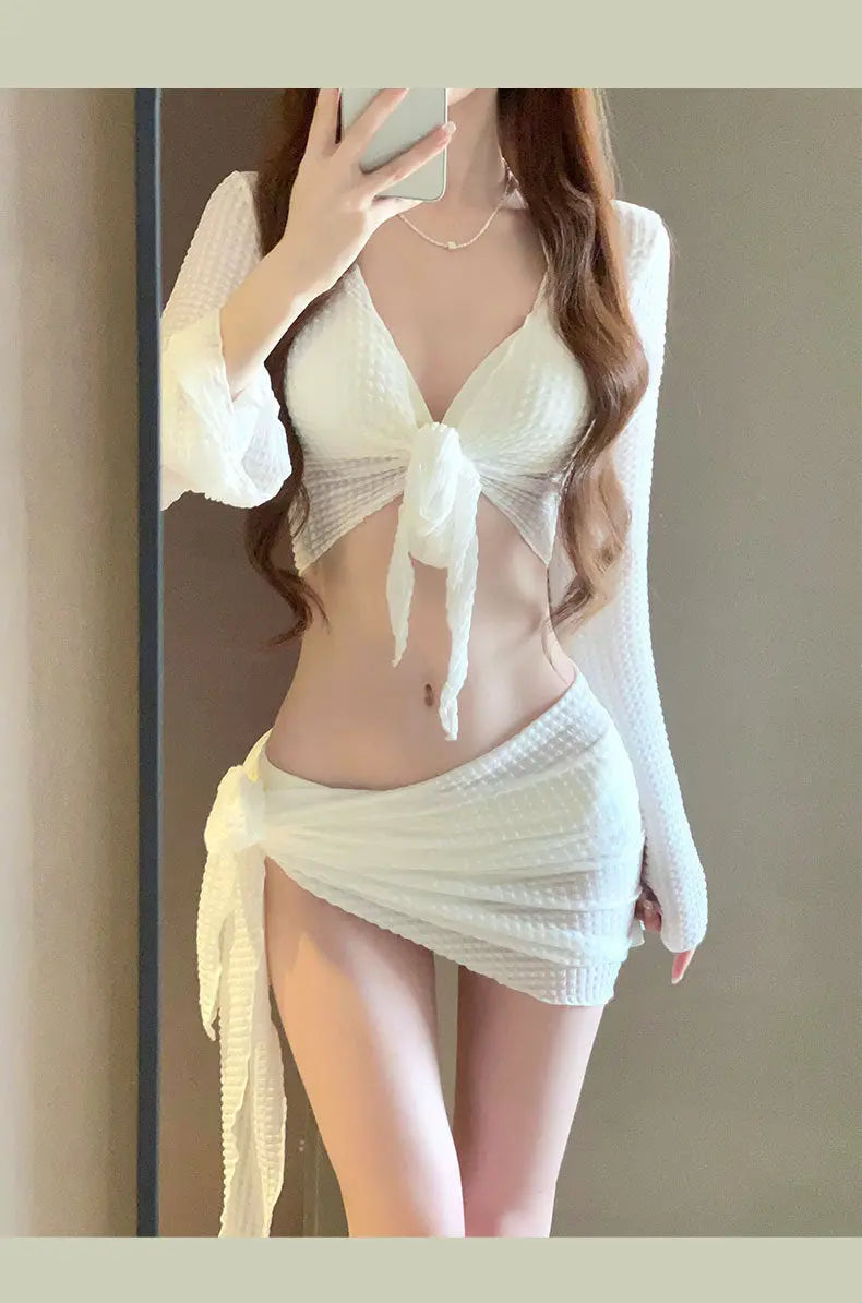 Women's IBG long sleeve swimsuit set with four pieces, featuring a stylish swimwear design and full coverage for swimming or beach wear.