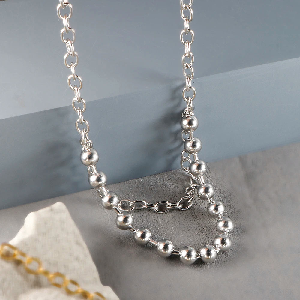 Stainless steel ball chain necklace by IBG, minimal everyday jewelry with small round beads, close-up view of the chain.
