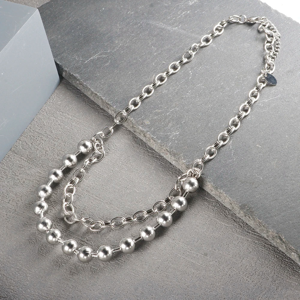 Close-up of IBG stainless steel ball chain necklace showing its sleek, minimal design suitable for everyday jewelry.